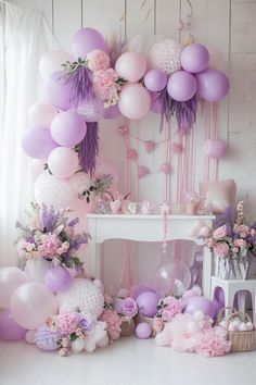 a room filled with lots of balloons and flowers