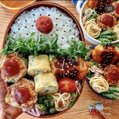 two bowls filled with different types of food on top of a wooden table next to plates of rice and veggies