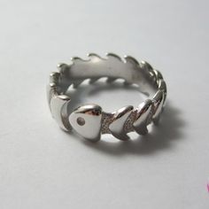 Dive into a unique style with our Silver Fishbone Ring, meticulously handcrafted to resemble a fish skeleton. Handmade in Greece- Free Worldwide Shipping- Large Variety of Rings This quirky and eye-catching piece is perfect for ocean lovers and those who appreciate unique, nature-inspired jewelry. This delicate fish ring is perfect for stacking with other rings or wearing on its own. Crafted from high-quality 925 stering silver, this ring is designed to be adjustable, ensuring a comfortable fit Weird Rings, Fish Rings, Skeleton Band, Chunky Silver Jewellery, Nature Inspired Fashion, Fish Skeleton, Fish Ring, Silver Jewlery, Ocean Inspired Jewelry