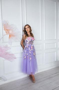 Feel like a fairy tale princess in our dreamy purple floral dress!  With delicate flower appliques, a flowy midi length,  and lace detailing on the back, this dress is perfect for weddings,  proms, or photo sessions.  And the best part? Bow ties on the shoulders add a touch of romance  and playfulness to this enchanting dress. Message me for any kind of customizations. Spring Prom Princess Evening Dress, Spring Princess Style Prom Dress, Spring Prom Dress In Princess Style, Princess Style Prom Dress For Spring, Purple Tulle Dress For Wedding, Purple Princess Dress For Prom Season, Purple Evening Dress For Homecoming And Prom, Princess Style Floral Applique Prom Dress, Spring Princess Dress With Sweetheart Neckline