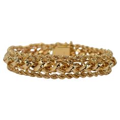 A perfect choice when looking for the bold look of gold but in a modest width. Multi-dimensional, with an interesting braided design, the highly polished 14 karat yellow gold is trimmed with accenting 14 karat yellow gold roping to create this desirable bracelet. At a moderate 1/2 inch width, this substantial gold statement piece is sized to fit most and presents beautifully when worn independently or combined with other pieces in your jewelry wardrobe. Of quality construction, the bracelet is f Luxury Yellow Gold Braided Bracelets For Formal Occasions, Luxury Yellow Gold Braided Bracelets For Women, Formal Yellow Gold Jewelry With Interwoven Design, Formal Heirloom Yellow Gold Chain Bracelet, Heirloom Yellow Gold Jubilee Bracelet, Elegant Bracelets With Interwoven Design As Gift, Elegant Bracelets With Interwoven Design For Gift, Elegant Yellow Gold Jewelry With Interwoven Design, Luxury Yellow Gold Braided Bracelets For Gifts