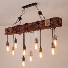 a chandelier made out of wooden planks with light bulbs hanging from it