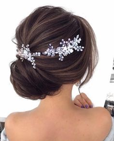 a woman with her back to the camera wearing a bridal hair comb in silver