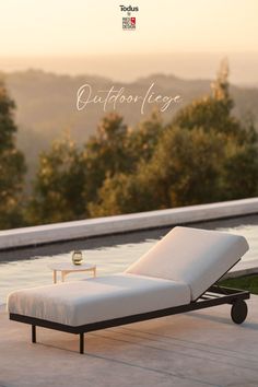 an outdoor lounge chair sitting on top of a wooden deck next to a swimming pool