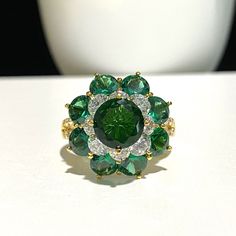 15K 610 Solid Yellow Gold Emerald, White Topaz Flower Cluster Ring ...Marked 610 means 61% of Gold...Total of weights 6.2grams...Size 8.25...Measure of Face 19.5MM....It's in very good condition. Green Emerald Jewelry In Flower Shape, Green Emerald Flower-shaped Jewelry, Green Emerald Flower Jewelry, Green Flower-shaped Emerald Jewelry, Fine Jewelry With Green Flower-shaped Gemstones, Elegant Flower Ring With Multi-stones, Fine Jewelry In Green With Flower Shape, Green Cluster Multi-stone Jewelry, Fine Jewelry In Flower Shape And Green Color