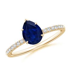 a yellow gold ring with an oval blue sapphire and white diamonds on the side, set in