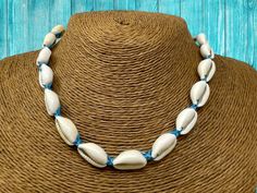 Elevate your beach style with this authentic Hawaiian Cowrie & Puka shell necklace. Expertly handcrafted, this necklace showcases the exquisite beauty of pristine white shells that evoke memories of serene beach waves and sun-kissed sands. Features: Quality Craftsmanship: Each necklace is delicately hand-strung, ensuring a long-lasting piece to add to your collection. Adjustable Design: Wear it close to your neck as a choker or loose for a more laid-back look.  Our adjustable clasp ensures a com Beachy Shell Necklace For Festival Season, Shell Strand Jewelry For Vacation, Handmade Shell Necklace For Summer Beach, Beachy Shell Necklace For Festivals, Beach Season Shell Jewelry For Festivals, Beachy Strand Jewelry For Festival, Summer Shell Strand Necklaces, Summer Shell Strand Necklace, Bohemian Shell Necklaces For The Beach