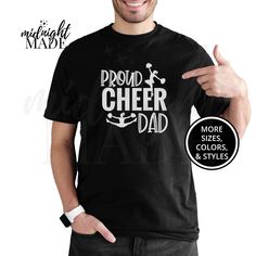 Looking for a unique cool Cheerleader Dad gift? This Midnight Made® Proud Cheer Dad T-shirt Tee is sure to delight! This sport parent shirt is a perfect Birthday, Big Game, Meet, or Competition gift for a Cheerleader Dad. This under 30 dollars novelty graphic Cheer Dad Tshirt Top is also a great present or gift idea for Christmas, Hanukkah, or other Holidays. T-SHIRT DETAILS:  Made to order and individually printed directly on the item (NOT an iron-on decal) on a comfortable, high quality, 100% cotton (fiber content may vary depending on color) short-sleeved T-Shirt. The back is blank, unless pictured otherwise. Multiple colors (light designs on dark shirts, dark designs on light shirts, and high-contrast full-color designs print well on either dark or light shirts) and sizes (Infant/Baby, Light Shirts, Sports Parent, Dark Designs, Dad Tshirt, Christmas Hanukkah, Pregnancy Shirts, High Contrast, Color Shorts, Big Game