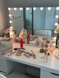 a vanity with lights and cosmetics on it