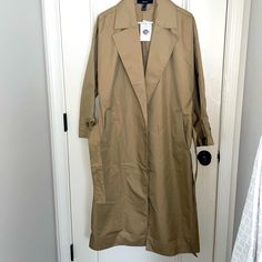 Nwt Never Worn Beige/Tan Trench Coat With Deep Pockets, Matching Belt Attached. No Front Buttons. Excellent Condition. Khaki Collared Outerwear For Day Out, Collared Khaki Outerwear For Day Out, Forever 21 Oversized Outerwear For Fall, Casual Work Outerwear From Forever 21, Casual Outerwear From Forever 21, Casual Forever 21 Outerwear For Work, Forever 21 Button-up Outerwear, Spring Outerwear With Pockets From Forever 21, Forever 21 Spring Outerwear For Work