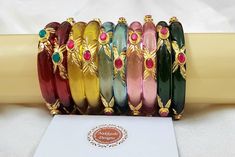 Designer bur bangles with rich kundan work on four sides available in set of 5 colours red green yellow pink blue all available in pair. A premium product. Handmade Multicolor Kundan Bangle, Handmade Multicolor Kundan Bracelets, Pink Kundan Bangle For Gift, Pink Kundan Bangle For Festivals, Pink Kundan Bangle For Festive Occasions, Multicolor Temple Jewelry Bangle For Festivals, Multicolor Handmade Bangle For Puja, Handmade Multicolor Bangle For Puja, Multicolor Temple Jewelry Bangle For Festive Occasions