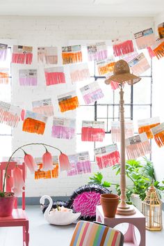 a room with chairs, plants and pictures on the wall