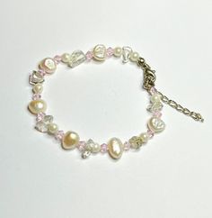 This Freshwater Pearl and Crystal Beaded Bracelet is made by me using high quality materials including: White freshwater pearls, glass beads and tiny faceted pink Crystal beads and finished with a lobster claw closure and extension chain.  It looks so elegant on and would go with so many different outfits. Length: 7 inches plus extension chain. Pink Pearl Bracelet With Pearl Charm, Pink Pearl Bracelet With Pearl Drop, Pink Beaded Dainty Pearl Bracelet, Dainty Pink Beaded Pearl Bracelet, Pink Pearl Beaded Bracelets For Jewelry Making, Pink Pearl Beaded Bracelets For Parties, Adjustable Pink Pearl Bracelet With Pearl Drop, Pink Pearl Drop Bracelet, Pink Dainty Pearl Bracelet