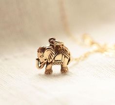 Welcome to BijouxbyMeg! Handcrafted jewelry, personalized just for you :)★Please be sure to take note of my current processing times (which does not include shipping time) in the "Shipping & Policies" tab above▲▲ ❤ Elephant Necklace♥The most tiny & dainty everyday necklace. Featuring a gorgeous golden bronze elephant charm (12mm) that dangles from the most delicate & shimmering 14k gold fill chain. A gorgeous necklace that you will reach for everyday..Necklace measure 17 inches as pi Spiritual Vintage Charm Necklaces As Gift, Symbolic Charm Necklaces With Vintage Charm For Gifts, Symbolic Charm Necklaces With Vintage Charm As Gift, Spiritual Vintage Charm Necklace For Gifts, Symbolic Charm Necklace With Vintage Charm As Gift, Symbolic Vintage Charm Necklace For Gift, Unique Brass Charm Necklaces For Gifts, Unique Brass Charm Necklaces As Gifts, Unique Brass Charm Necklace For Gifts