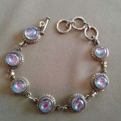 This Beautiful Sterling Silver Toggle Bracelet Features Iridescent Cabochons Of Mesmerizing Dichroic Glass. Vintage, Artisan-Made. Definitely A Piece To Show Off. 925 Sterling Silver Width: 8mm Weight: 22.6 Grams Nonsmoking Home, Quick Shipping. Price Negotiable, Make An Offer! Bundle - 20% Off Two Or More Items In This Closet. Tags: Boho, Bohemian, Hippy, Hippie, Gypsy, Sparkle, Metal, Dinner, Vacation, Festival, Party, Holiday, Date Night, Chic, Vintage, Art, Artist, Artisan, Casual, Iridescent, Hypnotize, Eclectic, Glass, 90s, Peasant, Silver, Dichroic, Fairycore, Resort Iridescent Round Glass Jewelry, Iridescent Glass Round Jewelry, Elegant Iridescent Bracelet Jewelry, Handmade Iridescent Bracelet, Adjustable Iridescent Glass Jewelry, Handmade Iridescent Metal Jewelry, Handmade Adjustable Iridescent Jewelry, Adjustable Iridescent Bracelet Jewelry, Adjustable Handmade Iridescent Jewelry