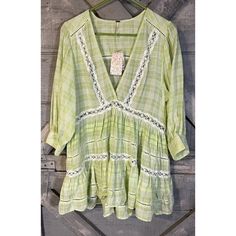 Add A Touch Of Bohemian Style To Your Collection With This Nwt Free People Blouse. The Mint Green Top Features A V-Neckline And Pullover Closure, With 3/4 Balloon Sleeves And Crochet And Embroidered Accents For A Unique Touch. Made Of Comfortable Cotton Material, This Relaxed Fit Tunic Is Perfect For Any Occasion. The Blouse Comes In Size L And Is Ideal For Those Who Love Designer, Bohemian, And Peasant Themes. Grab This Top And Pair It With Shorts Or Jeans To Complete Your Look. We Attempt To D Spring V-neck Blouse With Chikankari Embroidery, Cotton V-neck Peasant Top For Vacation, Summer V-neck Blouse With Chikankari Embroidery, Spring Green Cotton Tunic, Spring V-neck Blouse With Lace Work, Vacation V-neck Blouse With Embroidered Hem, Spring Green Tunic With Chikankari Embroidery, V-neck Blouse With Embroidered Hem For Vacation, Green Chikankari Embroidery Tunic For Spring