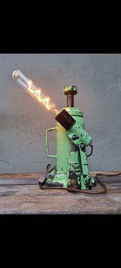 a green machine with a light on top of it's head and some wires coming out of it