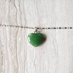 Beautiful heart jade necklace, Gorgeous translucent green. The pendant is made from nephrite jade mined from British Columbia, Canada. We currently only have the gold plated jump ring in stock. The pendant comes with a stainless steel jumpring. Option to buy sterling silver chain necklaces. Jade brings harmony and contentment to the wearer. In Asian cultures, Jade is revered as the good luck stone which can bring happiness, wealth, and friendship. 15mm x 15mm x 4.85mm 4.6 grams May Birthstone Heart Pendant Necklace, Heart Shaped May Birthstone Necklace With Heart Charm, Green Heart Necklace For Valentine's Day Gift, Heart-shaped Jade Jewelry For Gift, Heart Charm Necklace For May Birthstone Gift, Green Heart Charm Necklace As A Gift, Dainty Green Heart Pendant Necklace, Green Heart Charm Necklace For Gift, Dainty Green Heart Jewelry