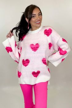 We've got all the heart eyes for this sweater featuring a thick material, round neckline, bell sleeves, and fuzzy pink hearts scattered on the front and back! Style this sweater with our Blaire Bell Bottoms to complete the perfect valentines day look! Model is wearing a small. Size Bust Waist Length Small 51" 50" 26" Medium 52" 51" 26.5" Large 53" 52" 27" Oversized Heart Print Sweater For Fall, Cute Heart Graphic Sweater For Winter, Playful Pink Crew Neck Sweater, Oversized Heart-shaped Sweater For Winter, Cute Winter Sweater With Heart Graphic, Cute Heart Graphic Sweater For Fall, Trendy Heart Print Sweater For Winter, Cozy Long Sleeve Sweater With Heart Print, Trendy Fall Sweater With Heart Print