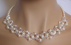 "Stunning Pearl and Crystal Necklace!  This gorgeous pearl and crystal choker necklace is made with white pearls and bicone crystals in AB finish. Aurora Borealis is a rainbow like coating that adds sparkle and all the colors from crystal through ping, gold even blue! It has all the sparkle you need for your special day! The perfect accessory for any bride or bridesmaid. Necklace details: - made with white pearls and AB crystals - measures 19.68\" (50cm) long, - finished with a Sterling Silver Lobster clasp and 1,5\" extension for an adjustable fit.  If You need any larger size, please let me know. This necklace will come in a pretty gift box - ready for gift giving. No extra charge for it. I do my best to photograph and describe my jewelry as accurately as possible, but please bare in min Swarovski Choker, Beaded Crystal Necklace, Swarovski Pearl Necklace, Pearl Necklace Wedding, Necklace Swarovski, Crystal Choker Necklace, Necklace For Girlfriend, Swarovski Necklace, Necklace Wedding