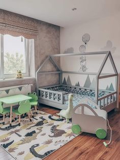 a child's room with green and white furniture, including a toddler bed