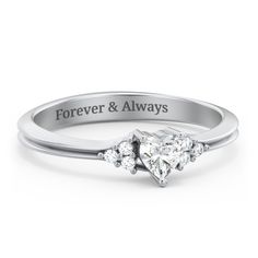 a heart shaped pink diamond ring with the words forever and always engraved on it's side