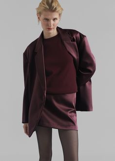 Color: Burgundy Midweight satin fabric Relaxed fit Mini length Concealed back zip closure Lined 100% Polyester Dry Clean By The Frankie Shop. Imported Chic Satin Skirt For Fall, Satin Skirt For Fall Evening, Satin Skirt For Evening In Fall, Fall Evening Satin Skirt, Solid Satin Skirt For Workwear, Fitted Satin Bottoms For Fall, Fitted Satin Outerwear For Night Out, Fall Party Outerwear In Satin, Fall Party Satin Outerwear