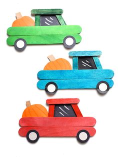 three wooden cars with pumpkins in the back and one painted green, orange and blue