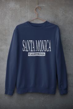 Super soft and comfy fleece sweatshirt made especially for the beach. Design has been distressed for a faded look. The sweatshirts in the pictures are solid color with soft fleece inner lining. They are not pigment-dyed or vintage. Santa Monica Sweatshirt, California Beach Shirt, Santa Monica Shirt, Beach Pullover, Beach Vacation Shirt, Spring Break Crewneck .: 50% Cotton 50% Polyester (Heather Colors are 40% Cotton 60% Polyester) .: Medium-heavy fabric (8.0 oz/yd² (271.25 g/m .: Loose fit .: Se Blue Letter Print Sweatshirt For Leisure, Casual Fleece T-shirt With Letter Print, Blue Casual Sweatshirt With Lettering, Casual Fleece Top With Text Print, Beach Pullover, Santa Monica California, Squad Shirt, Beach Design, California Beach