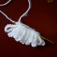 a white piece of yarn on a wooden table