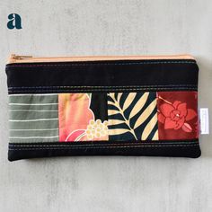 Keep your pens and pencils organized and stylish with our Black Taro Patchwork Pencil Cases. A slim zippered pouch adorned with colorful patchwork accents adds a fun twist to this black pencil case. Perfect for school, work, or everyday use. This listing is updated regularly with available pencil cases. Shown pencil case is a sample only. Patchwork print pattern will be the same, zipper colors may vary. No two pencil cases are the same. Product Details Cotton, linen cotton 8" wide x 4" tall Inte Pencil Case Design, Black Pencil Case, Pencil Organizer, Magnetic Earrings, Coffee Sleeve, Patchwork Print, Ipad Sleeve, Pens And Pencils, Zippered Pouch