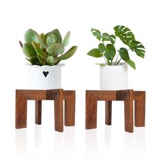 two small wooden stools with plants in them on a white background, one is made out of wood and the other has a potted plant