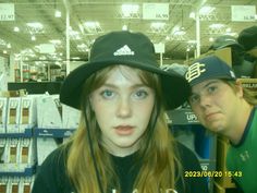 two young women wearing hats in a store