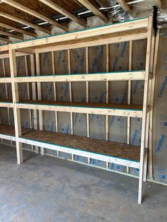 an unfinished room with shelves filled with wooden pallets