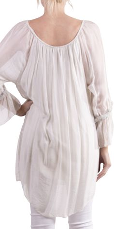 Long, stunning blouse/tunic with front tie and silver detail on sleeve. Can be worn off-shoulder or up. 30% silk, 70% viscose. One Size Fits All. Made in Italy. Spring Blouse With Sheer Flowy Sleeves, Spring Blouse With Sheer Sleeves And Flowy Fit, Spring Silk Off-shoulder Blouse, Spring Chic Blouse With Elastic Neckline, Chic Spring Blouse With Elastic Neckline, Off-shoulder Silk Blouse For Spring, Summer Tops With Gathered Sleeves, Flowy Fit, Summer Flowy Top With Gathered Sleeves, Summer Tops With Gathered Sleeves And Flowy Fit