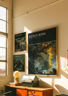 an office with posters on the wall and a wooden desk in front of two windows