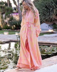 Unveil the harmony of elegance and comfort with our Gabriella Maxi Kaftan. Crafted with love, this piece embodies the ethereal beauty of dawn, gracing your form with its delicate pink hues and golden floral motifs. Every fold and drape of this robe tells a story of tranquility, inviting you to wrap yourself in its gentle embrace. Designed for those serene mornings or tranquil evenings, it becomes a sanctuary for your soul, reminding you of the calm and beauty that surrounds us. Size: Our model is wearing size M and has the following measurements: Height: 174 cm | 5 ft 9 inches Chest: 86 cm | 34 inches Waist: 63 cm | 25 inches Hips: 92 cm | 36 inches For the most flattering fit of our maxi kaftan, we recommend selecting a length that is approximately 25 cm | 10 inches shorter than your heig Spring Wrap Robe With Relaxed Fit, Spring Daywear Wrap Robe, Wrap Robe For Relaxation In Spring, Spring V-neck Robe For Loungewear, Spring Wrap Robe For Relaxation, Spring Beach Robe With Tie Waist, Flowy Wrap Robe For Spring, Spring Wrap Loungewear Robe, Spring Relaxation Robe With Tie Waist