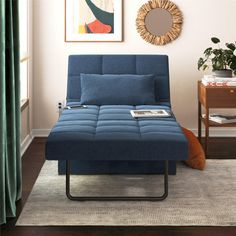 a futon bed sitting on top of a wooden floor next to a green curtain