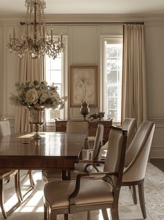 an elegant dining room with chandelier and chairs