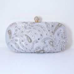 New to our Millennium collection, This beautiful romantic Beige crystal leaves embroidered and beads bridal clutch bag is made of very fine quality of crystal, beads rhinestones, fabric and metal and it comes with two chains, one chains length is 15 inches for a shoulder bad 44 inches long os cross body bag Detachable chain for your Big day! ► ABOUT YOUR ORDER * All items are neatly packaged in our beautiful jewelry boxes and elegant organza bags. * All items are 100% gift-ready. * Each order co Elegant Silver Embroidered Bags, Elegant Embellished Bridal Accessories For Mother Of The Bride, Embellished Clutch Evening Bag For Reception, Glamorous Handwork Clutch For Weddings, Glamorous Embroidered Evening Bag For Reception, White Embellished Evening Bag For Reception, Rectangular Hand Embellished Wedding Bag, Silver Evening Bag With Handwork, Elegant Silver Evening Bag With Handwork