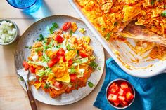 a plate of mexican food next to a bowl of salad