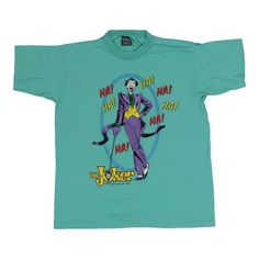 a green t - shirt with an image of a man in a joker suit on it