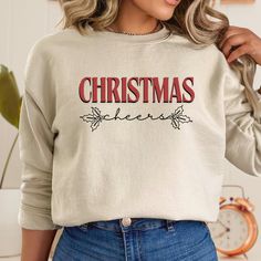 This Christmas Sweatshirt is the perfect gift idea for her, combining festive charm with cozy comfort. This cute Christmas sweatshirt makes a delightful addition to her holiday wardrobe, ensuring she stays warm and stylish throughout the season. T-Shirt Details: -Gildan 18000 Unisex Sweatshirt  -Polyester & Cotton  -Ribbed Knit Collar & Seams -No itchy Side Seams How to order? -Select the color you would like to order -Select the size you would like to order (See measurements details in photo) - Festive Long Sleeve Fall Sweatshirt, Fall Holiday Cotton Sweatshirt, Cotton Sweatshirt For Fall Holiday, Casual Festive Sweatshirt For Fall, Casual Fall Festive Sweatshirt, Festive Christmas Crew Neck Sweatshirt, Holiday Long Sleeve Tops As Gifts, Holiday Long Sleeve Tops As A Gift, Casual Christmas Sweatshirt For Festive Occasion