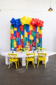 a table with chairs and balloons on it