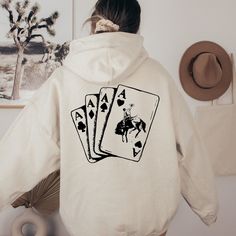 "Ace Card Cowboy Hoodie, Playing Card Sweatshirt, Country Girl Hoodie, Western Sweatshirt, Poker Card Games Hoodie Thank you so much for taking the time to browse my shop. Please feel free to reach out if you have any questions before or after purchasing.   🎨Warning: On products with a print chart in the listing, metallic print colors are printed as matte.✌✨ We design and cut each graphic out with a soft touch, use matte vinyl and a heat press. The result will last for many washes. PRODUCT DESC Western Hoodies, Cowboys Hoodie, Western Sweatshirts, Girl Hoodie, Ace Card, Country Hoodie, Poker Card, Gaming Hoodie, Western Style Outfits