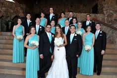 a group of people in formal wear posing for a photo