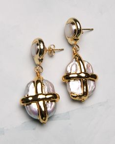 These gilded Pearl Gift Box Earrings will add a touch of sophistication to any outfit. The dangle design is sure to catch attention, while the luxurious pearls add a classic elegance. Perfect for gifting or treating yourself. 18k gold-plated, freshwater pearl, sterling silver post Lightweight | hypoallergenic | 0.8" drop Handmade in Los Angeles with imported materials Follow these tips to keep your jewelry looking its best! Formal Gold-plated Pearl Pendant Earrings, Gold-tone Pearl Drop Dangle Earrings, Luxury Pearl Chain Earrings For Gift, Classic Gold Metal Pearl Earrings, Luxury Pearl Charm Earrings As Gift, Elegant Metal Earrings With Pearl Pendant, Luxury Pearl Chain Drop Earrings, Luxury Metal Jewelry With Pearl Drop, Elegant Gold-tone Jewelry With Pearl Charm