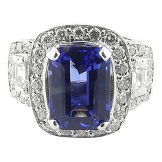 GAI certified 18K White Gold Genuine Tanzanite and Diamond Ring  This statement piece is set in white gold and has a genuine emerald cut blue tanzanite stone measuring at 4.14ct, with a AAA clarity grade.  The stunning tanzanite is blue with purple tones.  Approx. 1.26cts of emerald and round cut diamonds surround the tanzanite stone.  Diamond clarity: VS2 - SI1  Diamond color: G-H  Ring is a size 6.5 and can be sized.  The front of ring is 16.2 mm north to south and 21.1 west to east  This ring sits approx. 9mm above finger.  11.5 g / 7.3 dwt  Very good preowned condition. Just polished and certified by GAI. Certification paperwork included.  Estimated retail replacement value 8,500  Will be shipped priority mail or fed ex with insurance. Gia Certified Square Cut Sapphire Ring For Formal Occasions, Gia Certified Baguette Cut Tanzanite Ring, Radiant Cut Tanzanite Ring For Formal Occasions, Gia Certified Tanzanite Emerald Cut Rings, Classic Tanzanite Sapphire Ring In Radiant Cut, Tanzanite And Diamond Ring, Art Deco Sapphire Ring, Sapphire Eternity Ring, Art Nouveau Ring