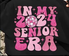 Introducing the Senior 2024 "Era" Tshirt. Celebrate your upcoming graduation in style with this exclusive shirt. Made with high-quality material for ultimate comfort, this shirt boasts a modern and trendy design. Show off your senior class pride and commemorate this milestone with the Senior 2024 "Era" Tshirt. This shirt is a front and back design, it has a pocket design that can be personalized with your graduates name or nickname I WILL RWACH PUT TO CONFIRM GRADUATES NAME ON TSHIRT OR YOU CAN EMAIL TO WHISKEYBLOSSOMDESIGNS@myyahoo.com Senior Class Shirts Design, Senior Tshirts, Seniors 2024, 2024 Era, Senior Class Shirts, Senior Sweatshirts, Class Shirt, Back Design, Design Show