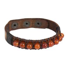 Beads of natural carnelian separated by waxed cord shimmer with a vibrant glow on this leather wristband bracelet from Thailand. Chaloemphon hand-crafts this dark brown bracelet from high-quality leather to create this stunning accessory. It features three brass snaps for adjustable length. Adjustable Leather Bracelets With Natural Stones, Adjustable Carnelian Beaded Bracelets, Adjustable Brown Carnelian Bracelets, Adjustable Spiritual Leather Bracelet With Natural Stones, Handmade Leather Beaded Spiritual Bracelets, Leather Bracelets With Natural Stones For Gifts, Handmade Leather Beaded Bracelets Spiritual Style, Handmade Leather Spiritual Beaded Bracelets, Handmade Spiritual Leather Beaded Bracelets